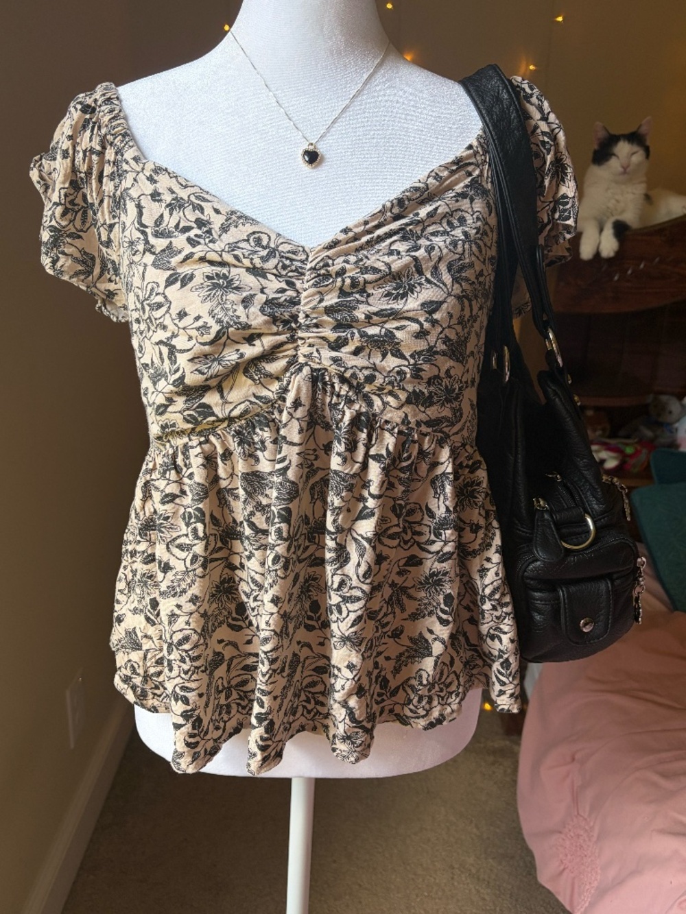 This beautiful tan/beige/black floral print blouse